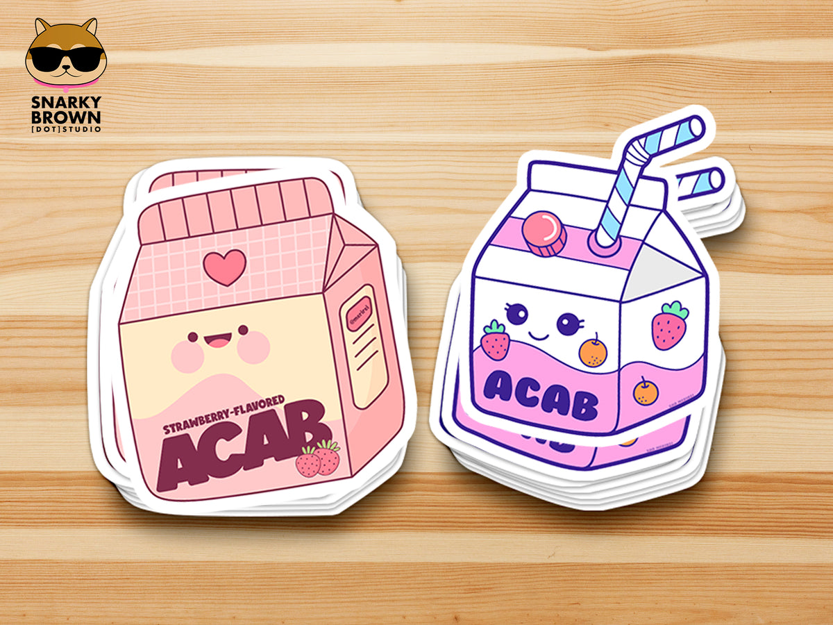 Two cute illustrated ACAB drink carton stickers on a light wood surface. One carton is pink and labeled strawberry-flavored ACAB, and the other is purple and labeled ACAB with a blue-striped straw.