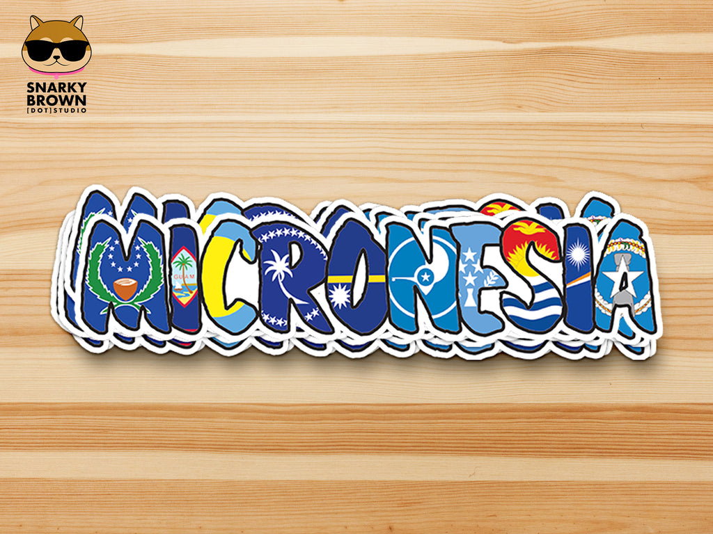 A die-cut sticker spelling 'MICRONESIA' in stylized letters filled with various blue and multicolor Pacific island flag designs, shown on a light wood background. The Snarky Brown Studio logo is visible in the top-left corner.